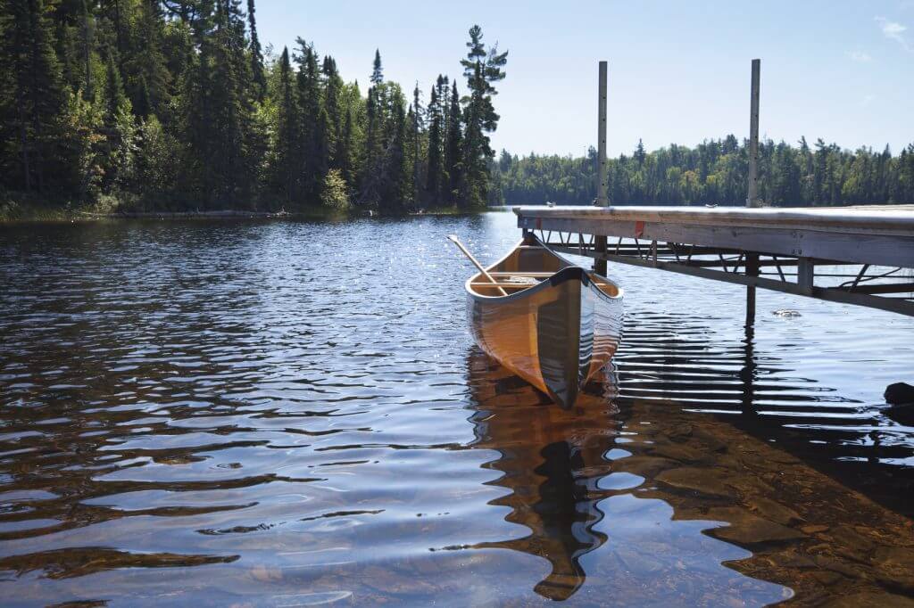 Canoe tied to a dock on a lake in northern Minnesota
