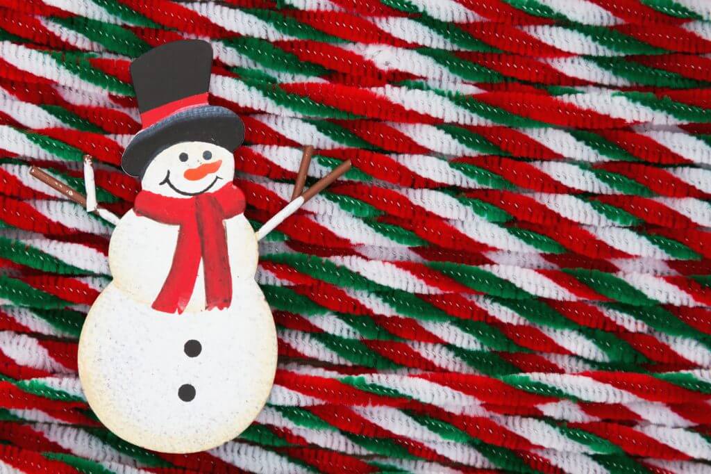 Snowman with candy cane pipes Christmas background