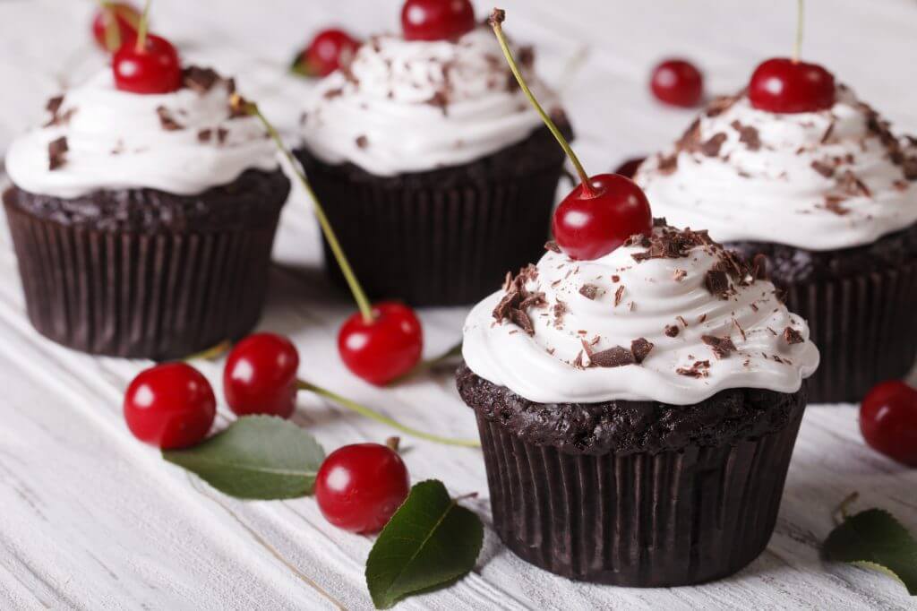 Chocolate cupcakes with cream and fresh cherry horizontal